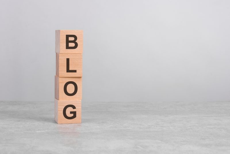 Home 2 Wooden,Cube,On,A,Concrete,Surface,With,Text,Blog.,Financial,